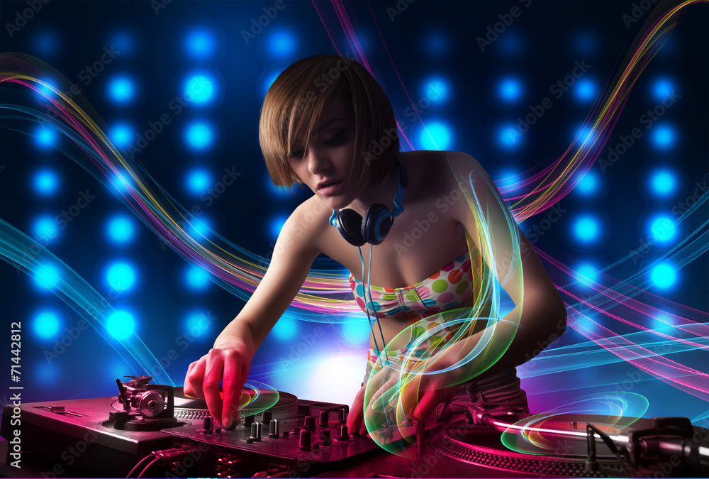 Young Dj girl mixing records with colorful lights - obrazy, fototapety, plakaty 