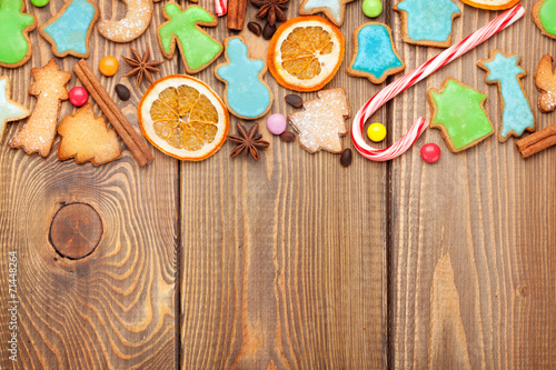 Christmas wooden background with spices and gingerbread cookies