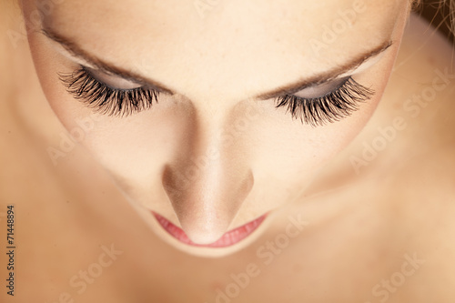female face and eyes with false eyelashes