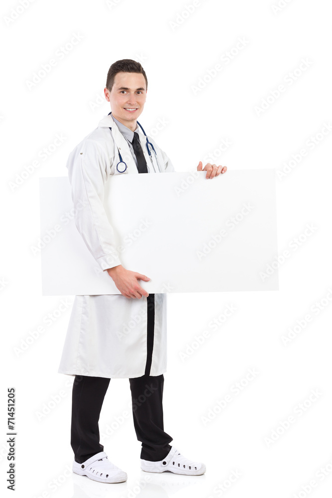 Male doctor holding an empty banner under the arm Male doctor holding an empty banner under the arm