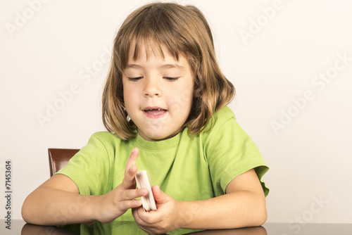 little girl with a deck of cards