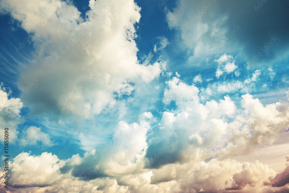 Fototapeta Bright blue cloudy sky, vintage toned photo background