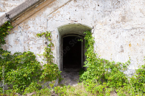 Dark empty doorway in old fortification wall  background texture