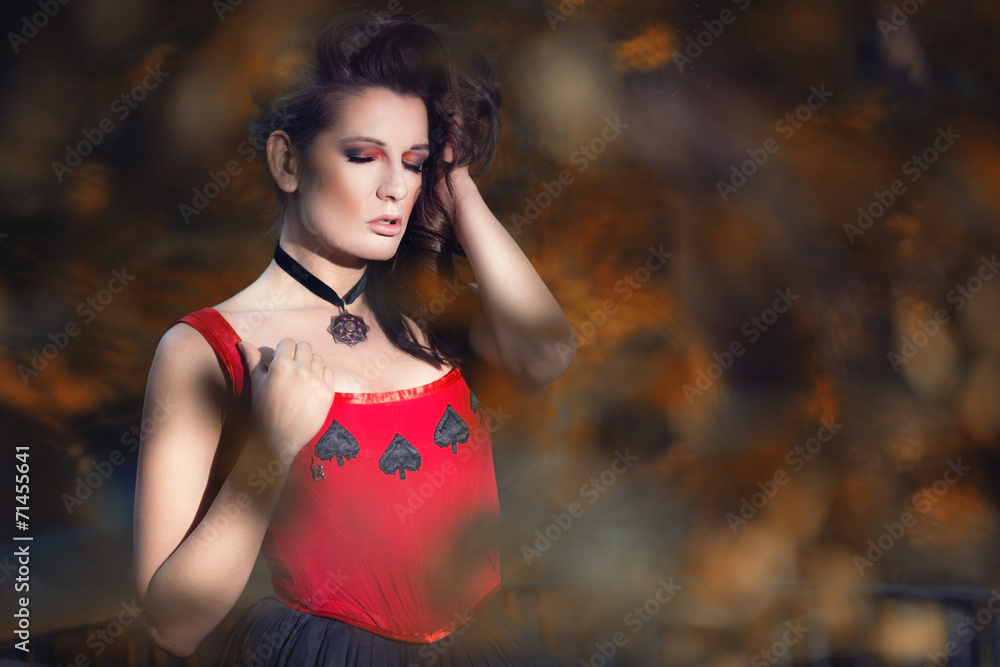 Mysterious woman in Victorian dress among the autumn leaves Mysterious woman in Victorian dress among the autumn leaves