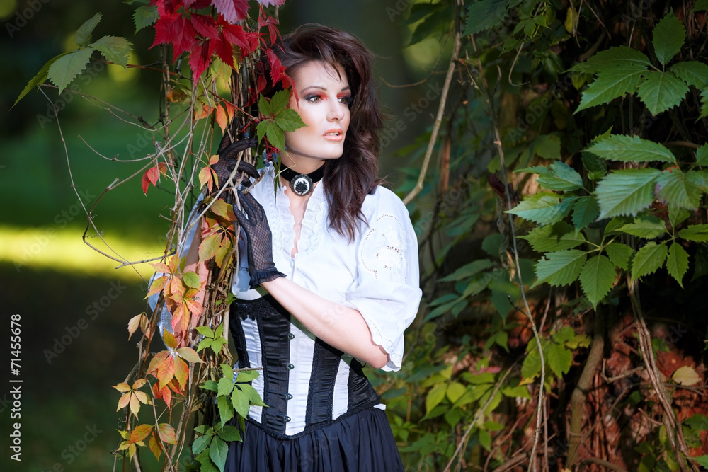 Mysterious woman in Victorian dress among the autumn leaves Mysterious woman in Victorian dress among the autumn leaves