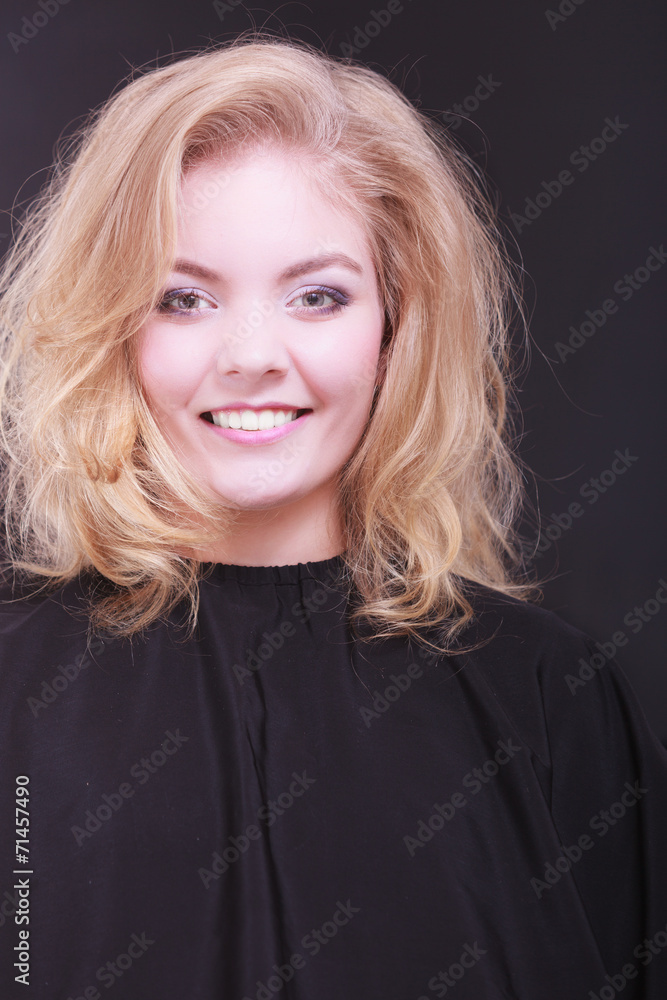 Beautiful smiling girl with blond wavy hair in hairdressing Beautiful smiling girl with blond wavy hair in hairdressing