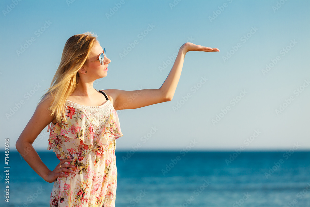 Summer vacation. Girl showing copy space on beach. Summer vacation. Girl showing copy space on beach.