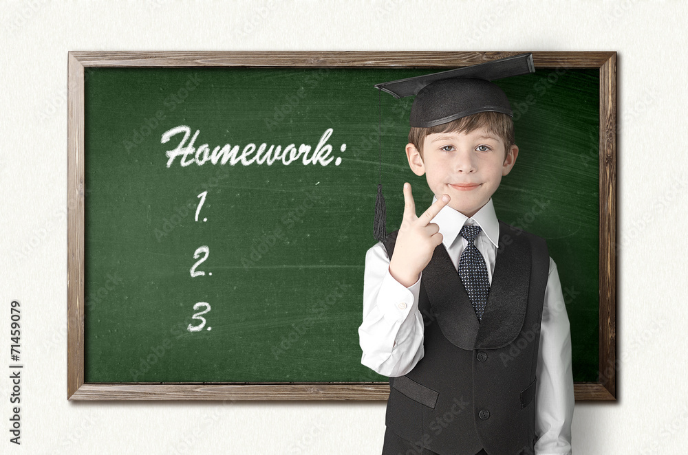 Cheerful little boy on blackboard. Looking at camera Cheerful little boy on blackboard. Looking at camera