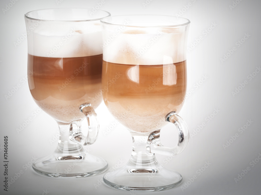Two glass mugs with handles of latte coffee Two glass mugs with handles of latte coffee