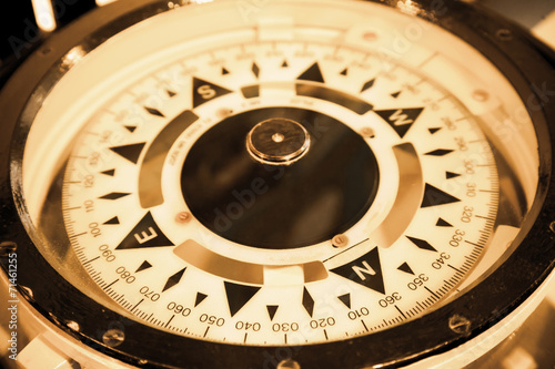 Magnetic compass on the captain bridge, vintage toned macro phot photo