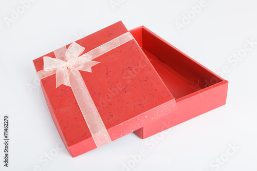 An empty red gift box with the lid off