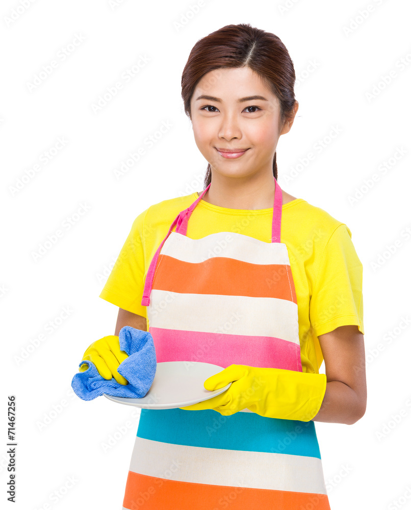 Asian housewife cleaning of bowl with towel Asian housewife cleaning of bowl with towel