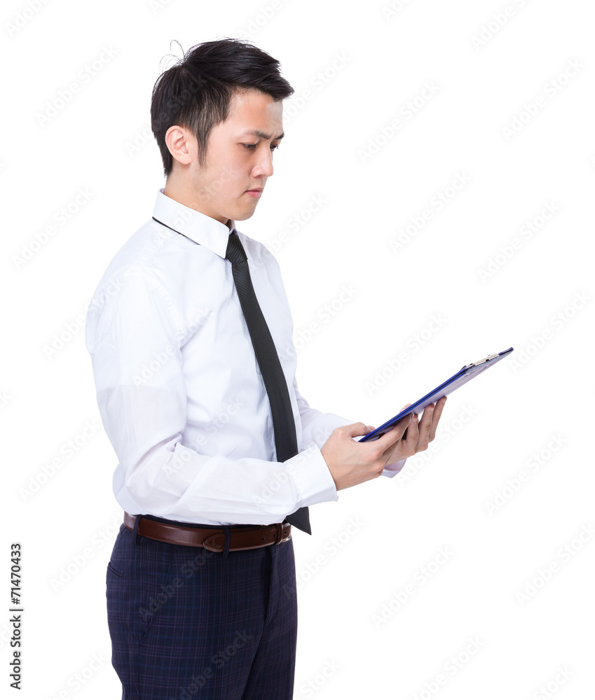 Businessman read on clipboard