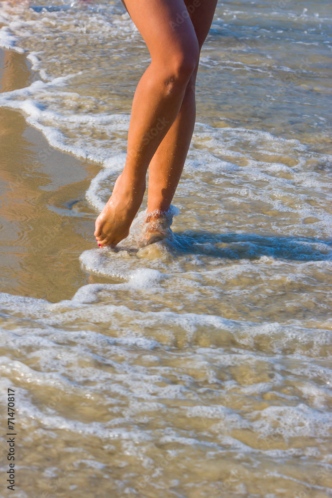 Female leg walking on the beach Female leg walking on the beach
