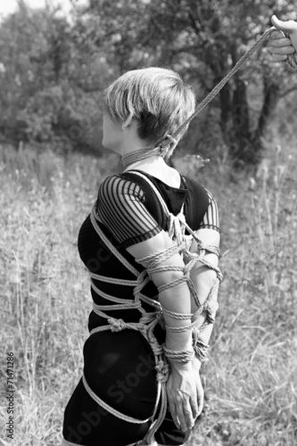 Bound woman with a noose around his neck. Shibari.