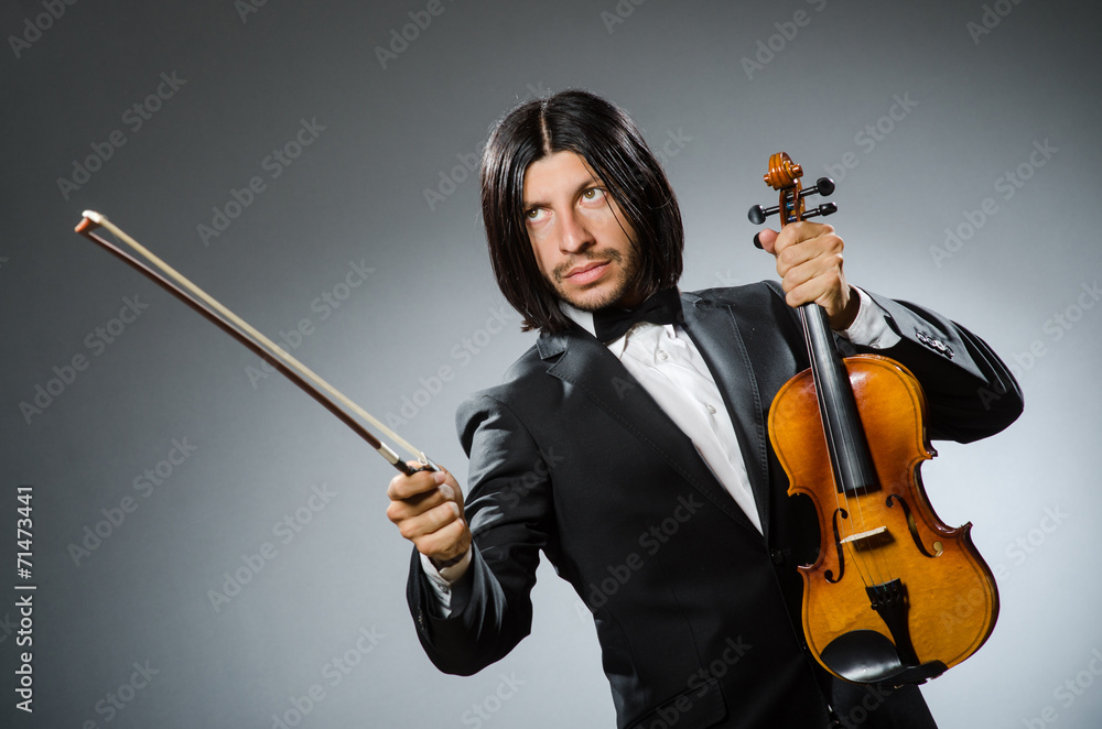 Fototapeta premium Man violin player in musican concept