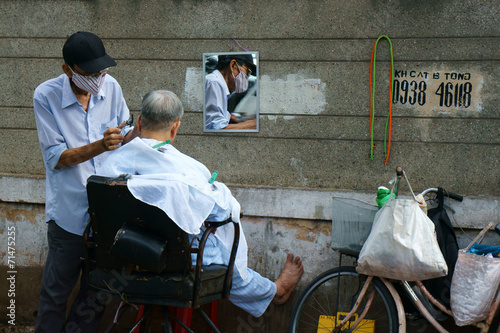 Vietnamese open air barber shop on pavement