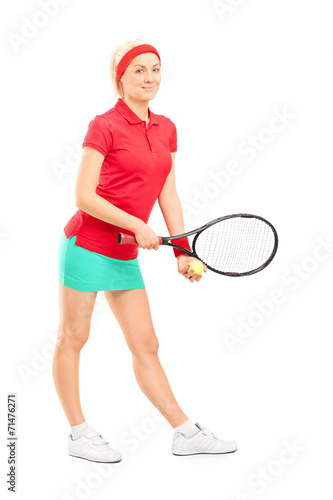 Female tennis player preparing to serve
