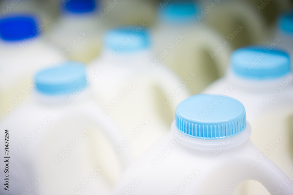 Bunch of milk bottles on fridge shelf in supermarket Bunch of milk bottles on fridge shelf in supermarket