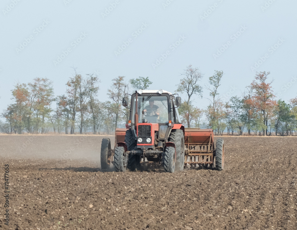 tractor and seeder planting crops on a field tractor and seeder planting crops on a field