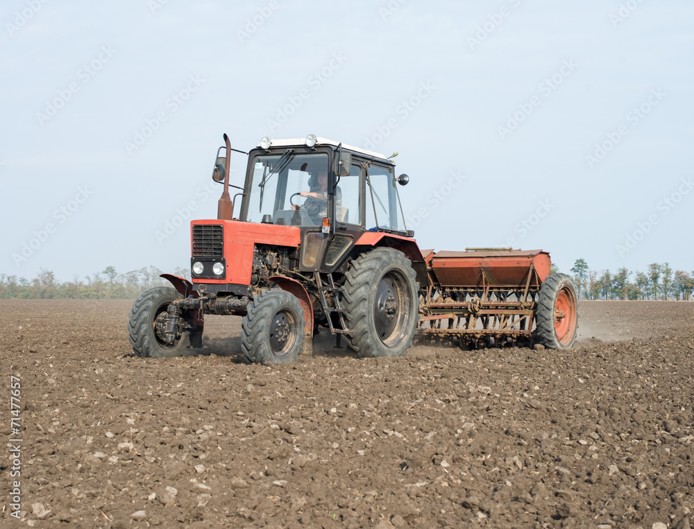 tractor and seeder planting crops on a field tractor and seeder planting crops on a field
