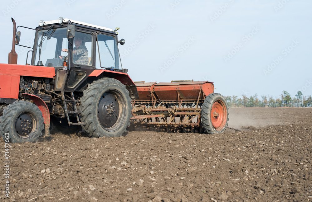 tractor and seeder planting crops on a field tractor and seeder planting crops on a field
