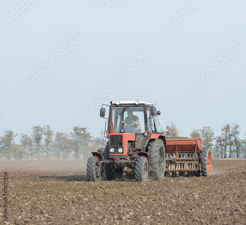 tractor and seeder planting crops on a field