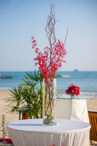 Luxury beach restaurant with tables and flovers in vase covered