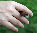 Avid smoker's hand while holding the cigar