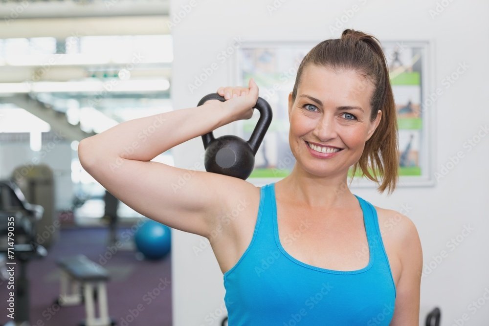 Fit brunette working out with kettlebell Fit brunette working out with kettlebell