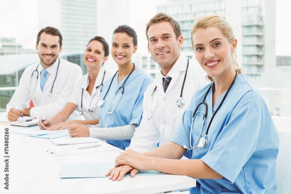 Male and female doctors sitting in row Male and female doctors sitting in row