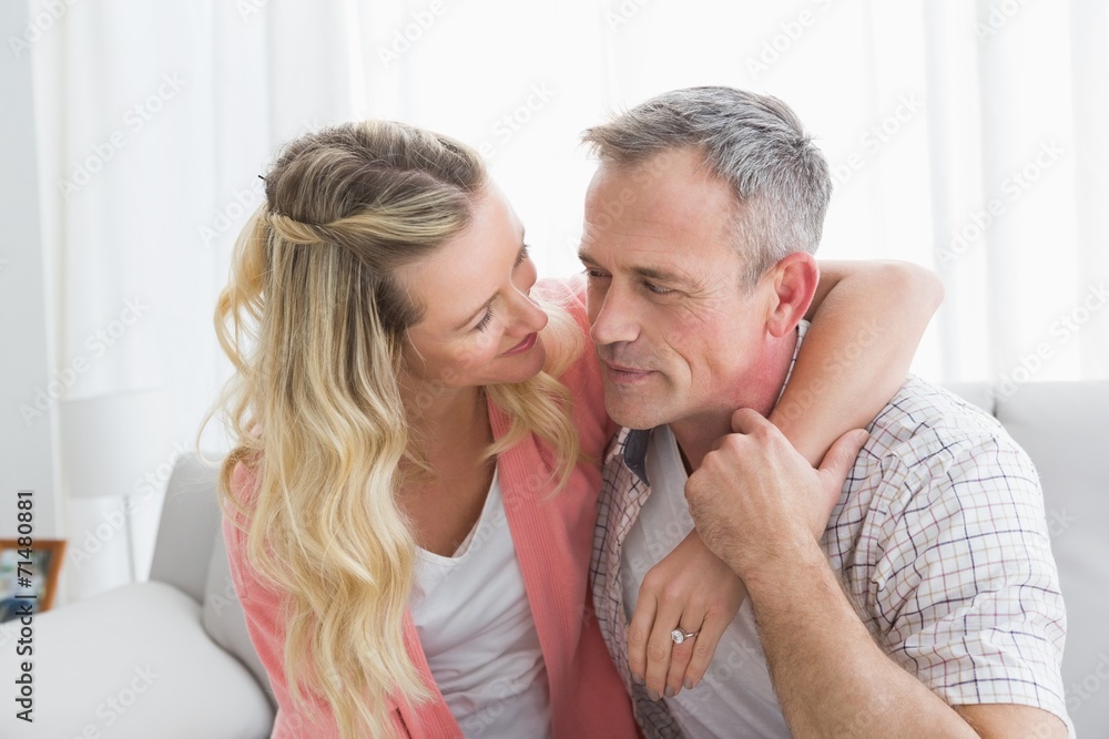 Portrait of a loving couple sitting on couch Portrait of a loving couple sitting on couch