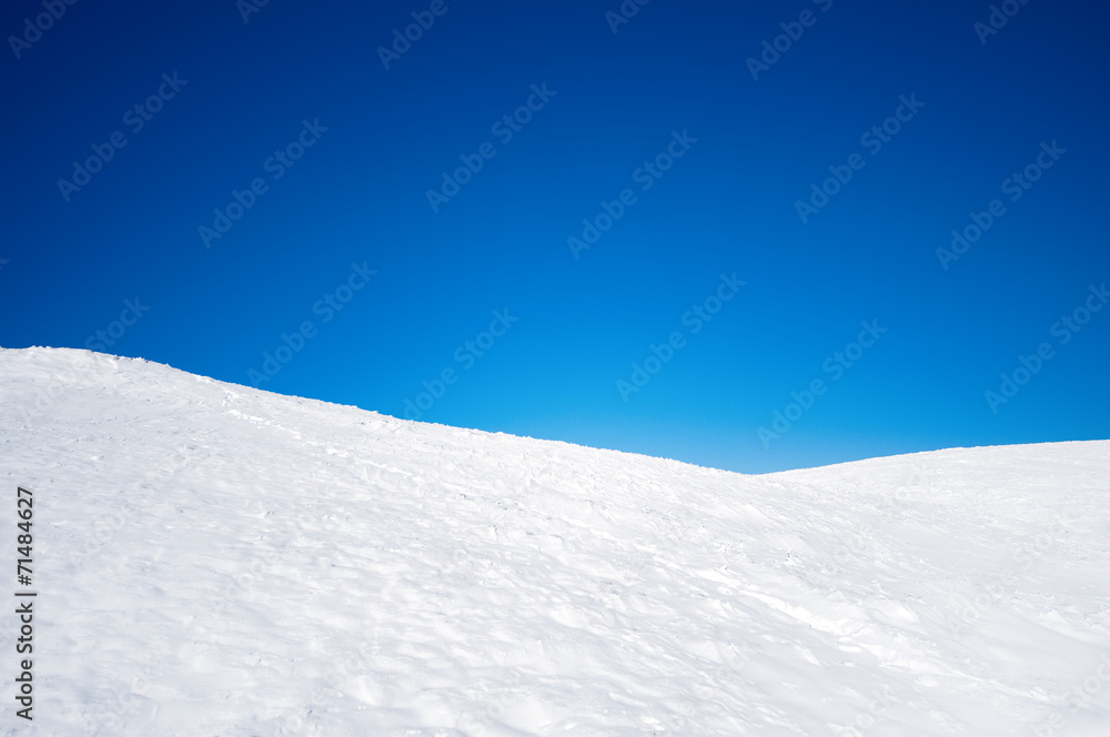 White snowy fields under a blue sky