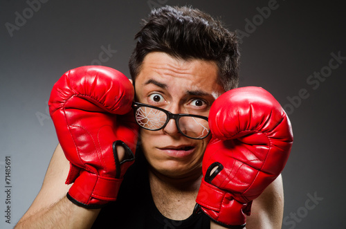 Funny boxer with red gloves against dark background © Elnur
