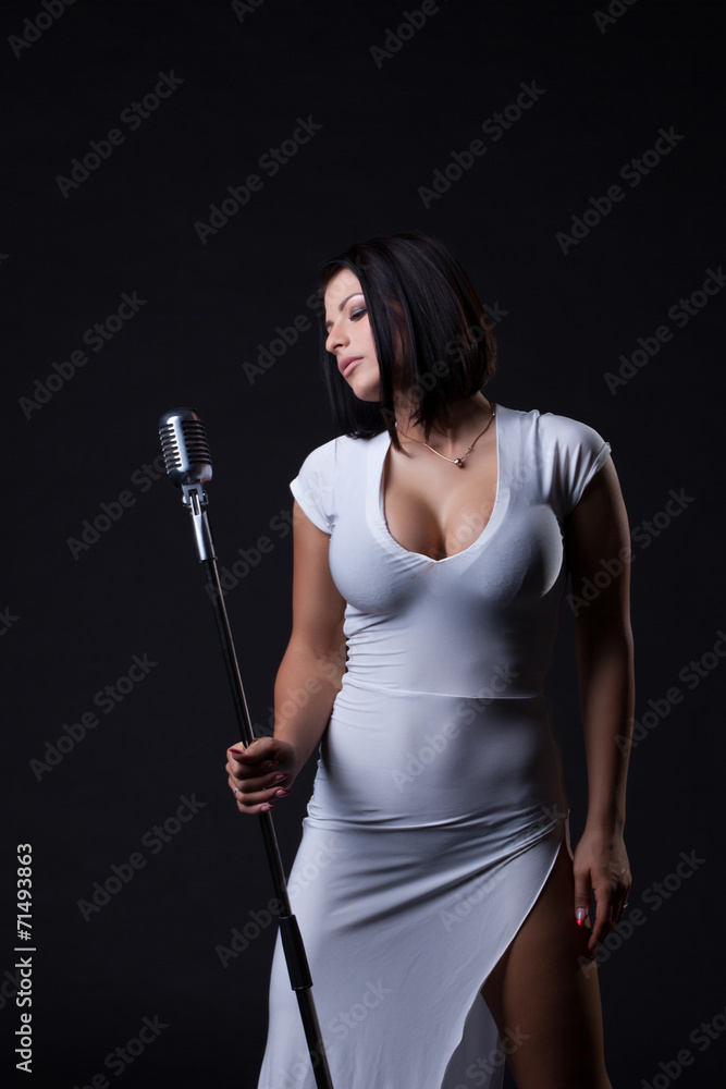 Image of busty slim singer posing in studio Stock Photo | Adobe Stock
