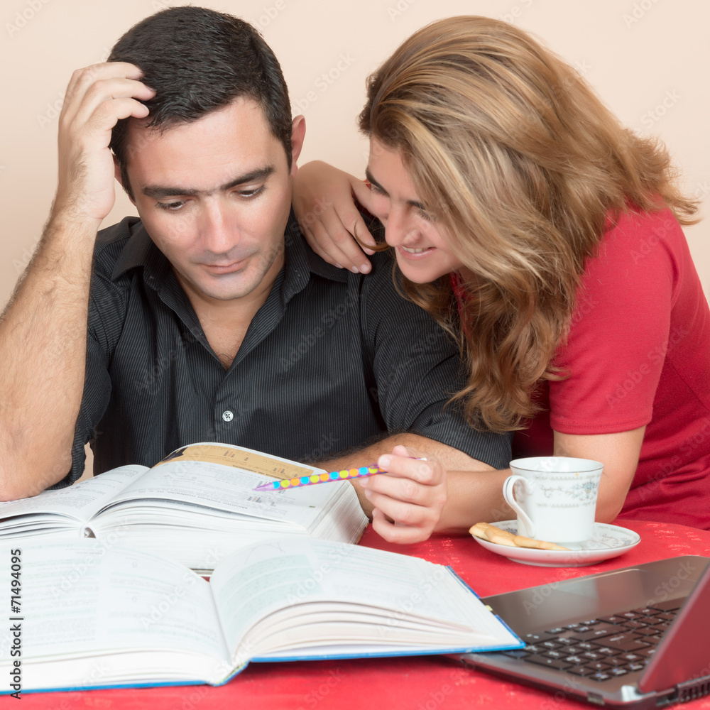 Hispanic man and woman studying at home Hispanic man and woman studying at home