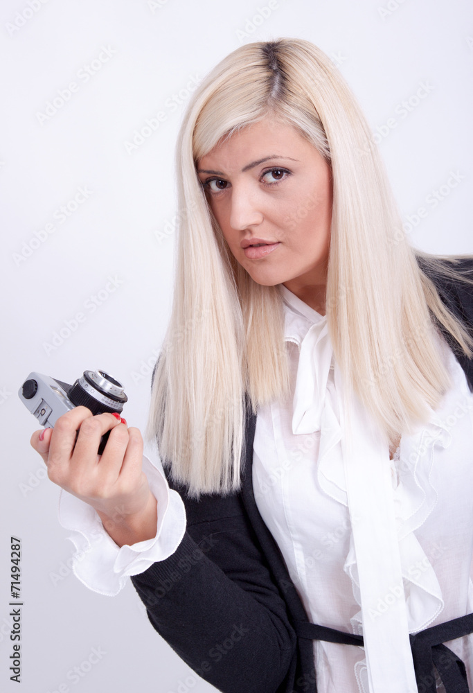 Blonde woman photographing over white background Blonde woman photographing over white background