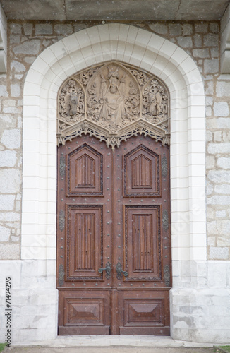Old wooden door with ornaments in a knight's castle. with snowin