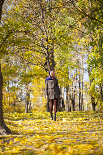 Young woman walking in autumn park © Andrey_Arkusha