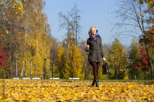 Young woman walking in autumn park © Andrey_Arkusha