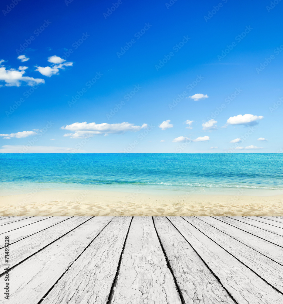 Empty wooden pier beside tropical beach