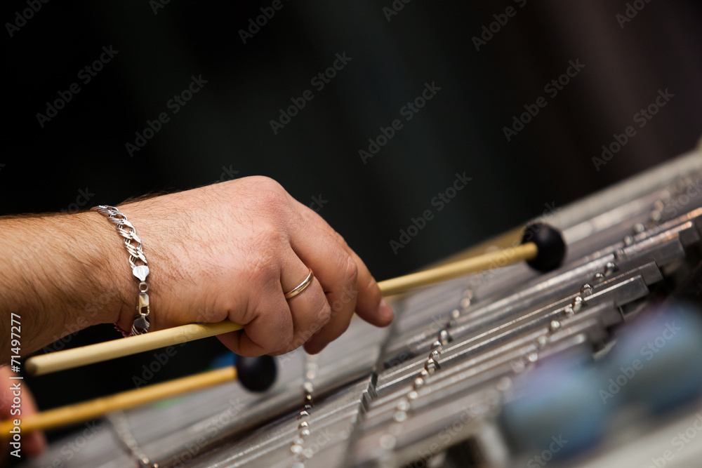 Human hands playing a glockenspiel closeup Human hands playing a glockenspiel closeup