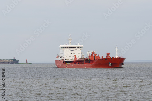 Cargo ship sailing in still water.