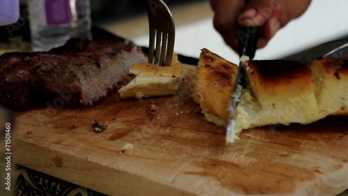 Flame Grilled Garlic Bread and Steak Cut into Portions on Board