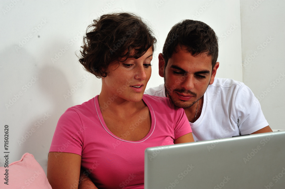 Couple sitting on sofa with laptop Couple sitting on sofa with laptop