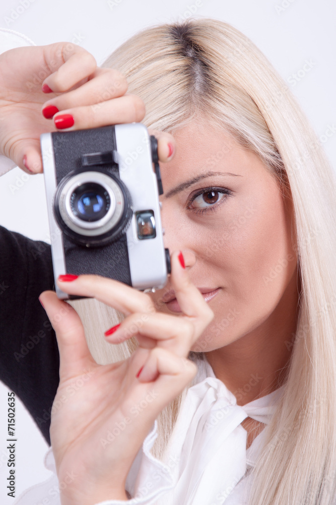 Blonde woman photographing over white background Blonde woman photographing over white background