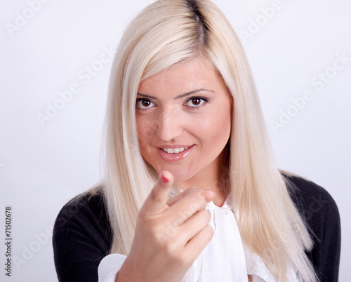 Portrait of casual dressed blond woman posing with arms crossed