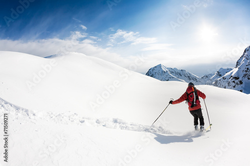 Skiing: male skier in powder snow. Italian Alps.