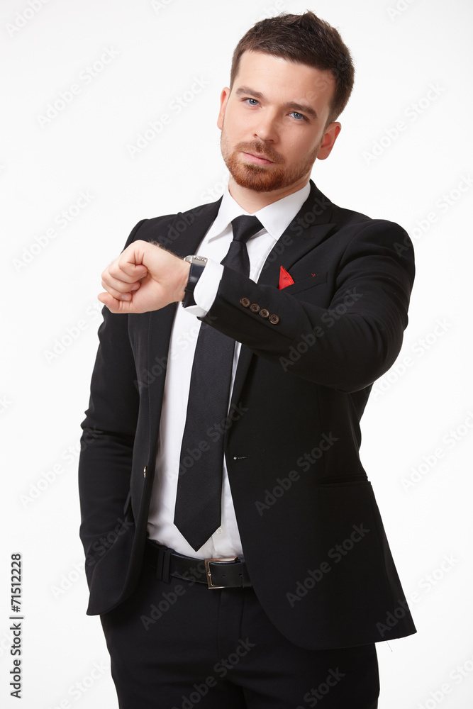 Businessman in a suit looking at his watch Businessman in a suit looking at his watch