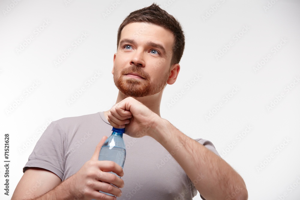 man in jeans and a T-shirt with bottle of water man in jeans and a T-shirt with bottle of water